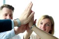 Happy business team giving high five in office Royalty Free Stock Photo