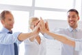 Happy business team giving high five in office Royalty Free Stock Photo