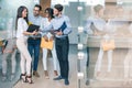 Happy business team having meeting in office hallway and discussing documents Royalty Free Stock Photo