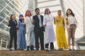 Happy business team making high hands in city background