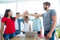 Happy business team putting their hands together Royalty Free Stock Photo