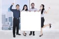 Happy business team show empty whiteboard Royalty Free Stock Photo