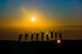 Happy business team silhouette sunrise