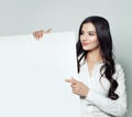 Happy business woman brunette smiling, showing white blank paper Royalty Free Stock Photo