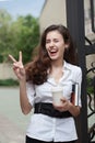 Happy business woman with coffee and notebook