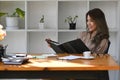 Business woman entrepreneur reading financial document while sitting at her office desk. Royalty Free Stock Photo