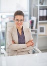 Happy business woman with eyeglasses in office Royalty Free Stock Photo