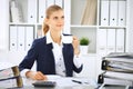 Happy business woman or female accountant having some minutes for coffee and pleasure at working place Royalty Free Stock Photo