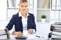 Happy business woman or female accountant having some minutes for coffee and pleasure at working place Royalty Free Stock Photo