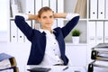 Happy business woman or female accountant having some minutes for time off and pleasure at working place Royalty Free Stock Photo