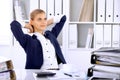 Happy business woman or female accountant having some minutes for time off and pleasure at working place Royalty Free Stock Photo