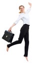 Happy business woman in formal wear jumping with briefcase. Royalty Free Stock Photo