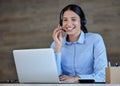 Happy business woman with headset working on laptop in office. Customer support operator answering calls. Professional Royalty Free Stock Photo