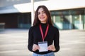 Happy business woman holding identification card on urban background. Business co-working teamwork concept Royalty Free Stock Photo