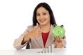 Happy business woman holding piggy bank and making thumbs up gestu Royalty Free Stock Photo