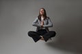 Happy business woman levitates in the lotus position and smiles, stress control at work,