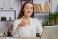 Happy business woman looking approvingly at camera showing thumbs up, like positive sign, good news Royalty Free Stock Photo