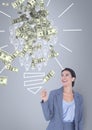 Happy business woman looking at money rain against blue background with bulb icon Royalty Free Stock Photo