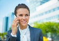 Happy business woman in office district talking smartphone Royalty Free Stock Photo