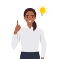 Happy business woman pointing hand up and bright light bulb appearing in the thought bubble. Idea and innovation concept. Flat Royalty Free Stock Photo