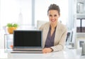 Happy business woman showing laptop blank screen Royalty Free Stock Photo