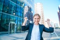 Happy business woman showing thumbs up while standing outdoors against office Royalty Free Stock Photo