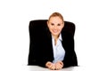 Happy business woman sitting behind the desk Royalty Free Stock Photo