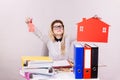 Happy business woman in office holding house Royalty Free Stock Photo