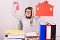 Happy business woman in office holding house Royalty Free Stock Photo