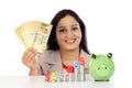 Happy business woman with stack of coins and holding rupee notes Royalty Free Stock Photo