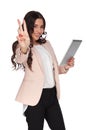 Happy business woman with tablet makes victory sign