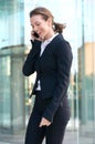 Happy business woman talking on cell phone outside Royalty Free Stock Photo