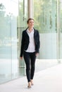 Happy business woman walking outside office building Royalty Free Stock Photo