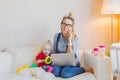 Happy business woman with toddler working on computer