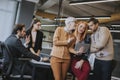 Happy business women working together online on a digital tablet in front of young team at the office Royalty Free Stock Photo