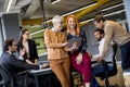 Happy business women working together online on a digital tablet at the office Royalty Free Stock Photo