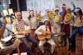 Happy business workers have fun and dancing in Santa hat at Xmas party and exchange gifts Royalty Free Stock Photo