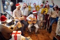 Happy business workers have fun and dancing in Santa hat at Xmas party together Royalty Free Stock Photo