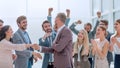 Happy businessman accepting congratulations of his colleagues Royalty Free Stock Photo