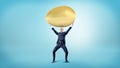 A happy businessman on blue background holds a huge golden egg over his head.