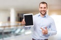 Man in blue shirt shows touch screen in a business center Royalty Free Stock Photo