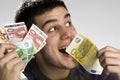 Happy businessman with bundle of euro money Royalty Free Stock Photo