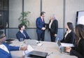 Happy businessman and businesswoman shaking hands at group board meeting. Professional business executive leaders making handshake Royalty Free Stock Photo