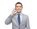 Happy businessman calling on smartphone