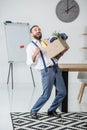 Businessman with cardboard box in hands quitting job