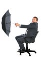 Happy businessman catching wind by umbrella