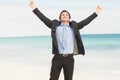 Happy businessman cheering at the beach Royalty Free Stock Photo