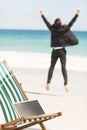 Happy businessman cheering at the beach Royalty Free Stock Photo