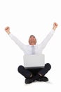 Happy businessman cheering and sitting with his laptop Royalty Free Stock Photo
