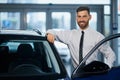 Happy businessman choosing new vehicle at showroom Royalty Free Stock Photo